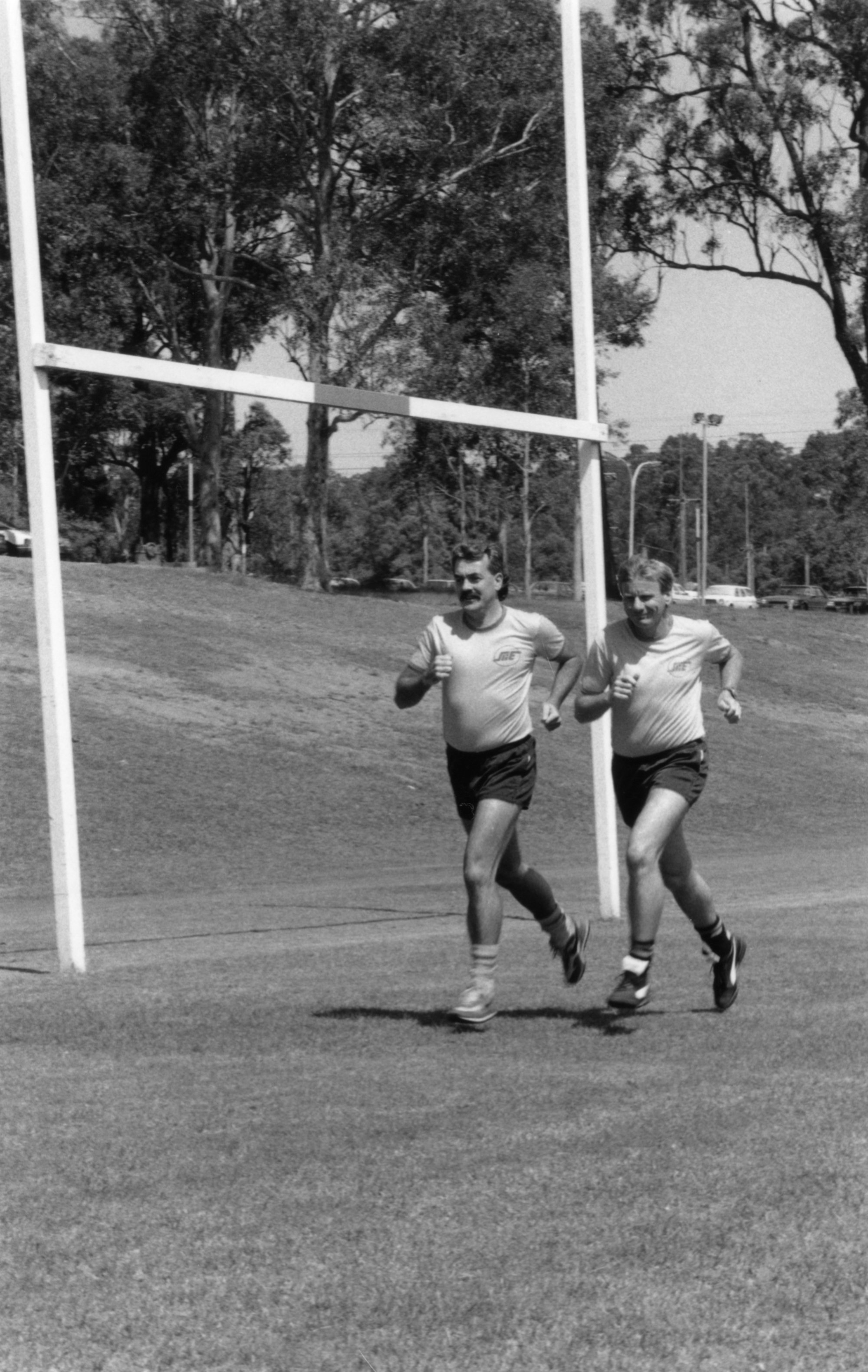 Rugby referees, Bruce Cook and Sandy McNeil, jogging on the University ...