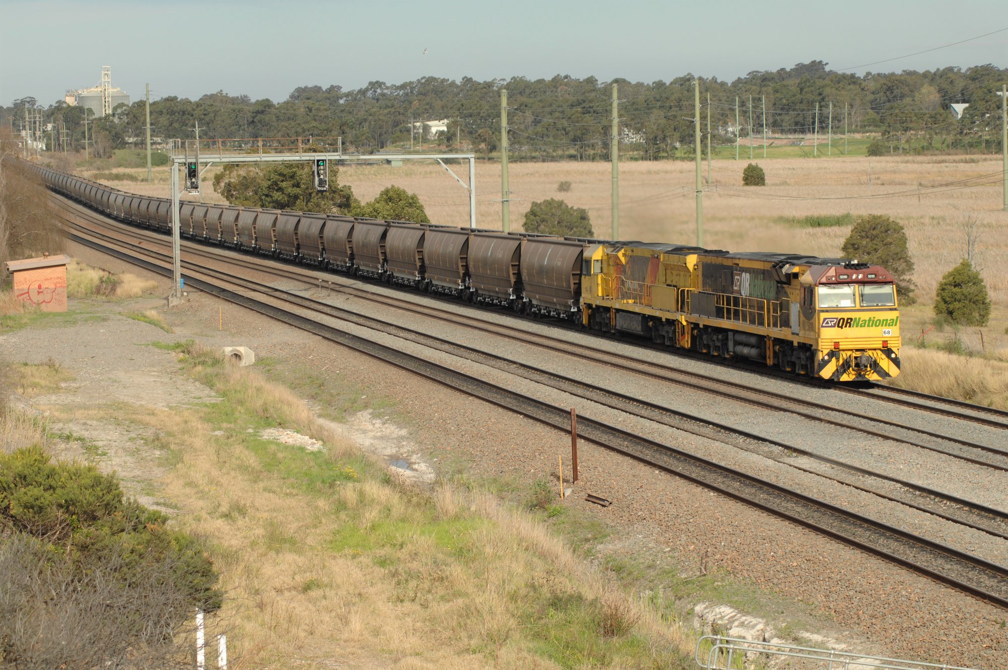 A QR National 5000 class and an Aurizon 5000 class approach Thornton on ...
