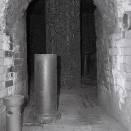 Entrance to beehive kilns, Cessnock Potteries, pipes in foreground, central chimney in background, 1980