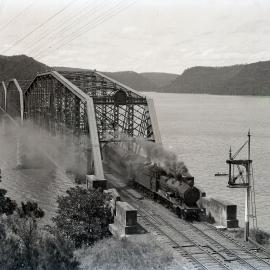 NSWGR C32 Class 4-6-0 Ten-wheeler Type express passenger locomotive hauling Sydney-bound passenger across the original Hawkesbury River Bridge, [1930s]