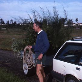 Norm George carrying rope, canoe trail planting bee, Shortland Wetlands, NSW, 1989-1994