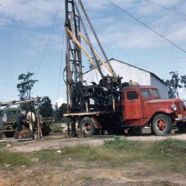 Stowage materials borehole drilling rig in operation, [Abermain Extended Colliery, NSW], August 1956
