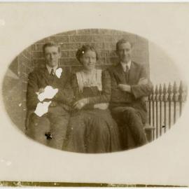 Portrait of two unidentified men and a woman
