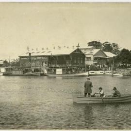 Men in a boat by the Manning River Dairy Co. Ltd.