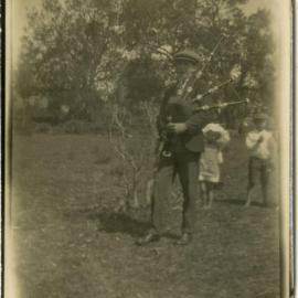 Photo of unidentified man and children with bagpipe