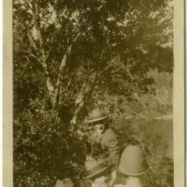 Three unidentified men and a woman in bushland