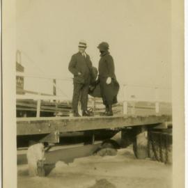 Unidentified couple standing on jetty