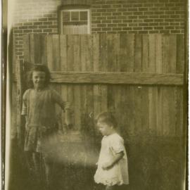 Photo of two unidentified children in a backyard