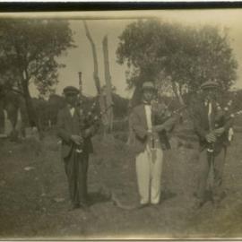 Photo of three men with bagpipes