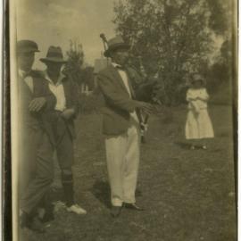 Portrait of man with bagpipes and company