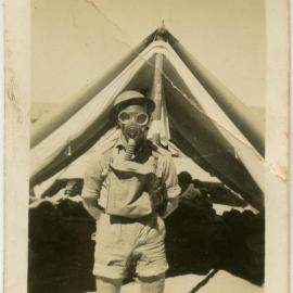 Photo of man in gas mask outside tent