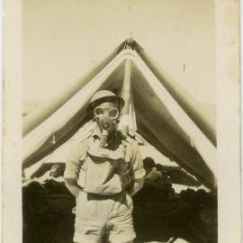 Photo of man in gas mask outside tent