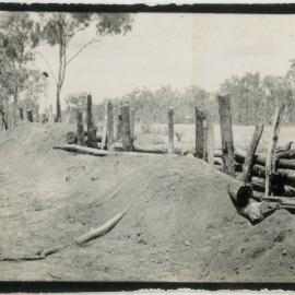 Photo of an earthen wall. "Chief raid shelter Moonamal[?]"