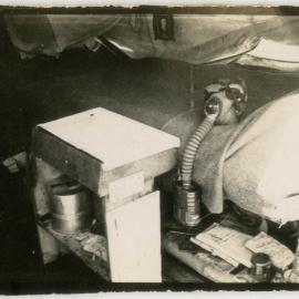 Photograph of a soldier's bunk, kit and gas mask