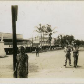 Photo of servicemen walking down a street in Darwin.
