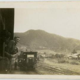 Photo of men hanging out of a railway car, presumably near Darwin