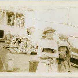 "Photographer" with tin hat and life jacket aboard unidentified ship.