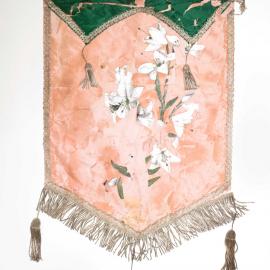 Lodge banner in peach and green, with print of white lilies