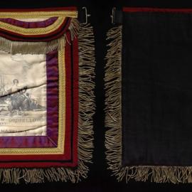 GUOOF Committee of Management, white apron with red, purple and gold detail