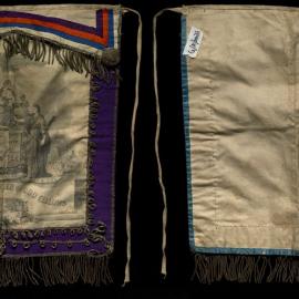 Apron, GUOOF, white with black print, purple trim and multicoloured flap