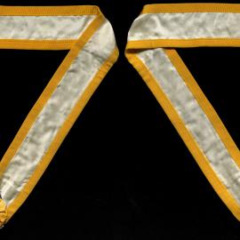 Collar, white with yellow trim, yellow rosette and gold symbols