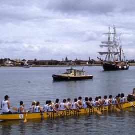 Dragon Boat and unidentified sailing ship in Newcastle Harbour with Stockton in background, NSW