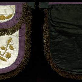White apron, purple trim, gold detail, Gordon Row
