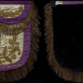 White apron, purple trim, dense ornate gold detail, Gordon Row