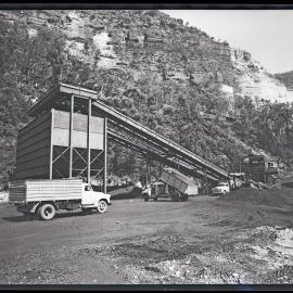 Wollondilly Extended Coalmine, trucks at mining depot, Burragorang Valley, NSW, 1960