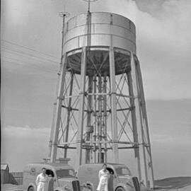 Two men standing alongside Kloster's Ford vans, NSW, 1958