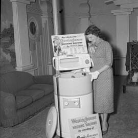 Presentation of a Westinghouse washing machine to Mrs Evans, 2HD Radio, 1958