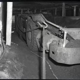Underground coal mine showing cable hooked on to truck, Burwood [No 3] Colliery, Whitebridge, NSW,  1957
