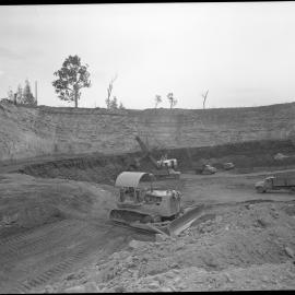 Tractor and excavator at open cut mine site, NSW, 1958