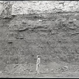 Man [viewing open cut site], NSW, 1958