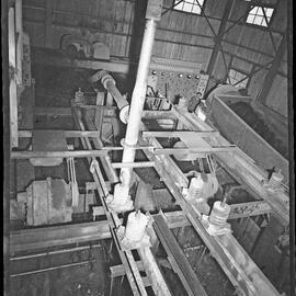 Machinery at colliery with man standing in background, 1958