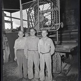 Three men standing at workshop gate, [Wyee State Mine], NSW,  1962