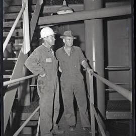 Two men standing on raised walkway, [Wyee State Mine], NSW, 1962