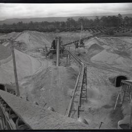 View overlooking industrial site and conveyor belts, 1963