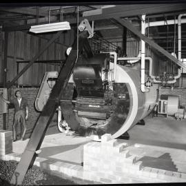 Singleton Dairy Co Op., man operating a Hodgkinson Low Ram Stoker, 1963