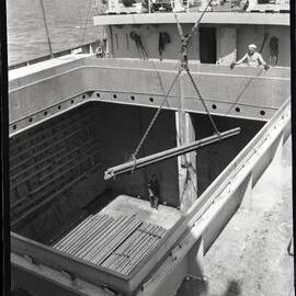 Loading steel on cargo ship, 1964