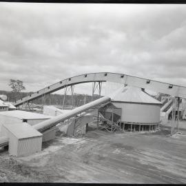 Factory buildings with a large and a small conveyor belt, 1963