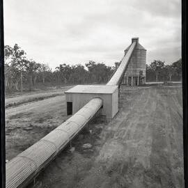 One large conveyor belt within two buildings, 1963
