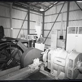 A worker operating factory equipment, 1963