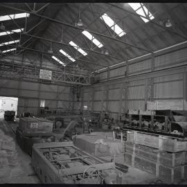 Inside factory building with steel equipment, 1963