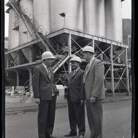 Picture of three men in suits and hardhats, 1963