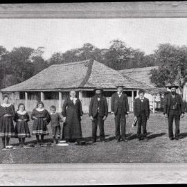 Group of people standing outside of [homestead]