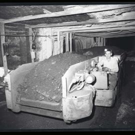 Man driving coal shuttle car, 1963
