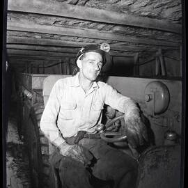 Coal worker underground in hardhat, 1963