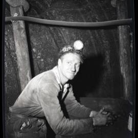 Coal worker in hardhat with head lamp, 1963