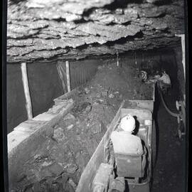 Man operating coal mining machine underground, 1963